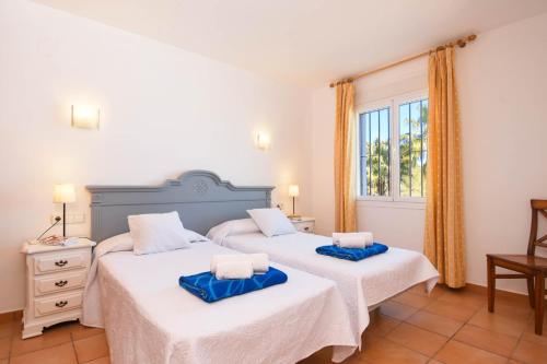 a bedroom with two beds and a window at Monte Azul in Jávea