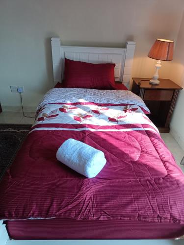 a bed with a pink blanket and a white pillow on it at Sofea Inn Bukit Merah - Suria A7733 in Kampong Selemat
