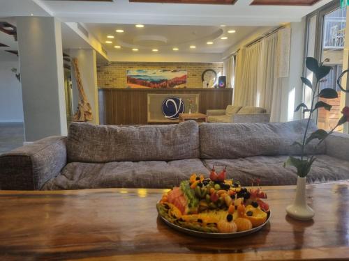 a plate of food on a table in a living room at Yarden Estate Hotel in Yesod Hamaala