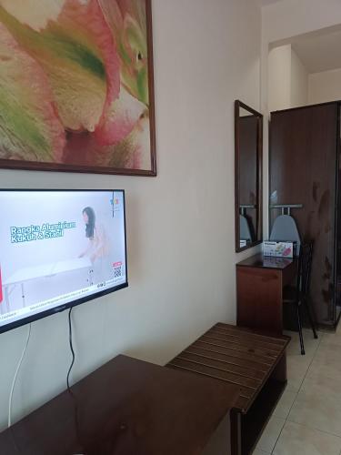 a flat screen tv hanging on a wall at Sofea Inn Bukit Merah - Suria A7733 in Kampong Selemat