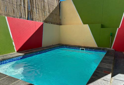 a swimming pool in a room with colorful walls at TaTe Village in Windhoek