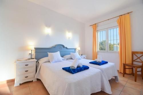 a bedroom with two beds with towels on them at Monte Blanco in Jávea