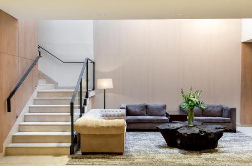 a living room with a couch and a table at Cyan Hotel de Las Americas in Buenos Aires