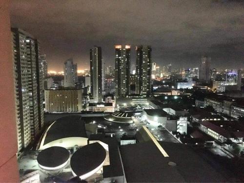 a view of a city at night with buildings at Birch Tower Private Studio with Manila City Metro View in Manila