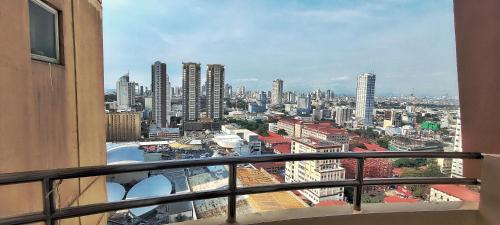 a view of a city from the balcony of a building at Birch Tower Private Studio with Manila City Metro View in Manila