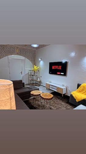 a living room with a couch and a tv at Welcome Hom in the heart of RABAT in Rabat