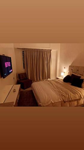 a hotel room with a bed and a television at Welcome Hom in the heart of RABAT in Rabat