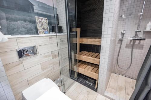 a bathroom with a shower with a toilet and a glass shower door at Original Sokos Hotel Lakeus Seinäjoki in Seinäjoki
