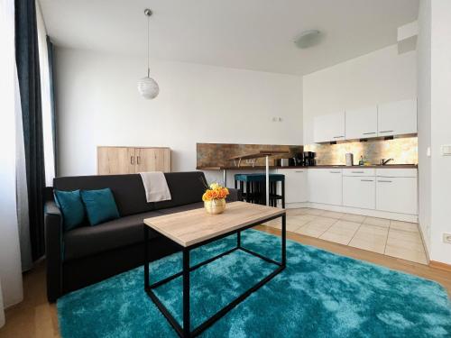 a living room with a couch and a table at Gemütliches Apartment mit Blick zur Frauenkirche in Dresden