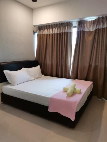 a bedroom with a bed with a pink blanket on it at Seri Sayang 2 Apartment suite with 2bedroom in Ayer Itam