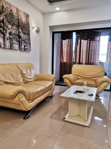 a living room with two couches and a coffee table at Seri Sayang 2 Apartment suite with 2bedroom in Ayer Itam