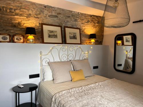 a bedroom with a bed and some pictures on the wall at Lemon House in Vélez-Málaga