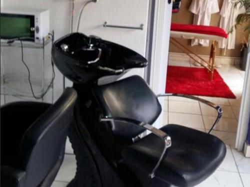 a black motorcycle seat in a room with a door at Le Chef BnB in Mthatha