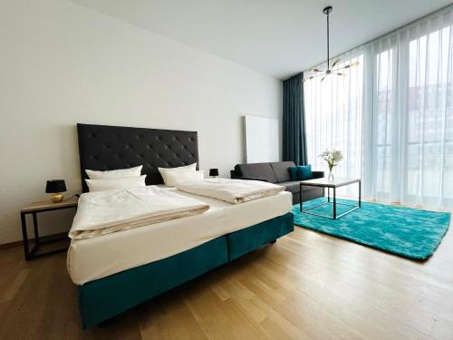 a bedroom with a large bed with a blue rug at Panoramastudio mit Blick zur Frauenkirche in Dresden