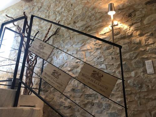 a stone wall with signs on a stair case at Bergerie Truphemus de Savoillan in Savoillan