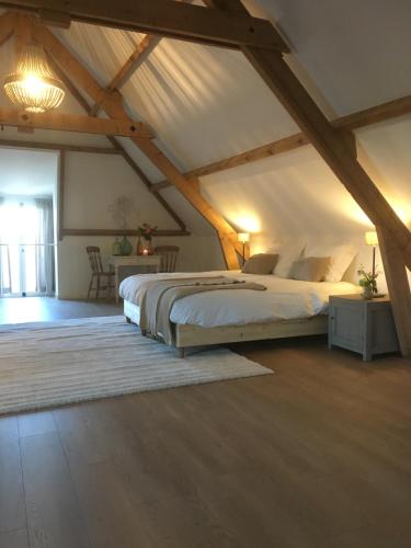 a bedroom with a large bed in a attic at House of Flowers 