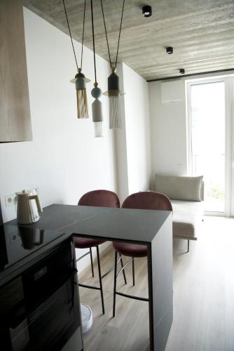 a dining room with a table and some chairs at J. Ralio apartamentai (monkey) in Vilnius