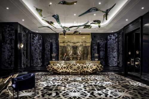 a lobby with black walls and a ceiling with butterflies at Bisha Hotel Toronto in Toronto