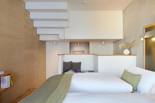 a bedroom with a large white bed in a room at Wedina Serviced Apartments in Hamburg