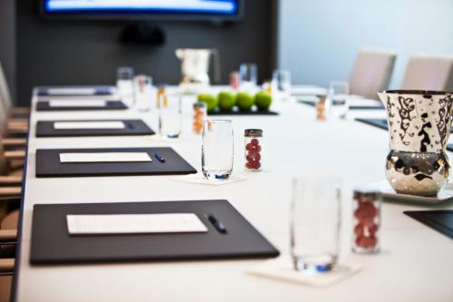 a long white table with glasses on it at Loews Regency New York Hotel in New York