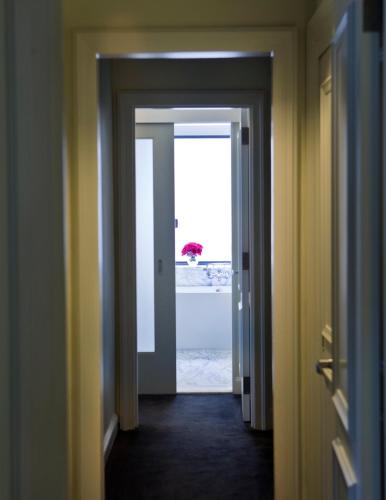 a hallway with an open door with a view of the ocean at Loews Regency New York Hotel in New York