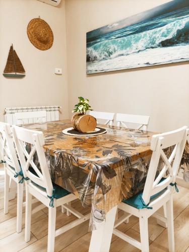 a dining room with a table and chairs at Luxury Beach House in Torvaianica