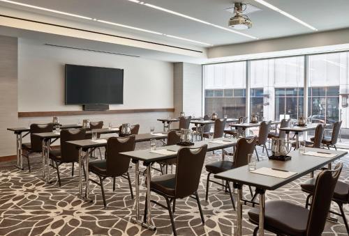 a conference room with tables and chairs and a flat screen tv at Loews Chicago Hotel in Chicago
