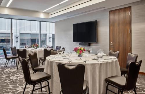 a conference room with tables and chairs and a flat screen tv at Loews Chicago Hotel in Chicago