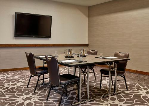 a conference room with a table and chairs and a flat screen tv at Loews Chicago Hotel in Chicago