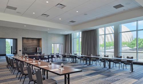a conference room with tables and chairs and large windows at Loews Kansas City in Kansas City