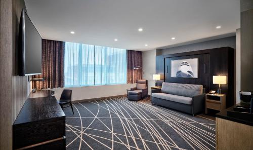a hotel room with a couch and a television at Loews Kansas City in Kansas City