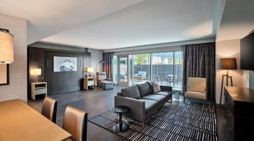 a living room with a couch and a table at Loews Kansas City in Kansas City