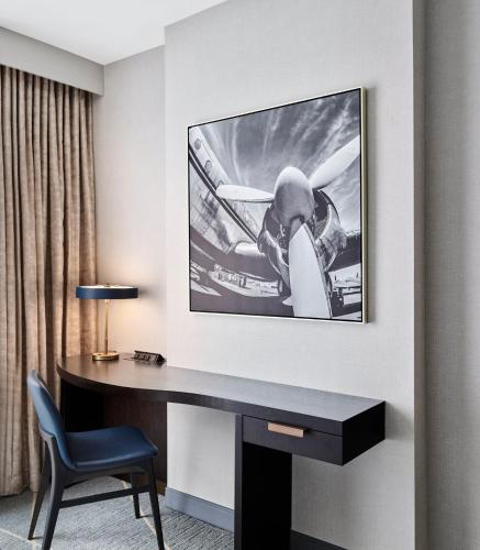 a desk in a hotel room with a picture of a plane at Loews Kansas City in Kansas City