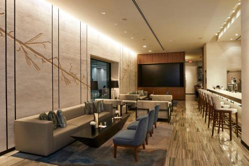 a lobby of a hotel with couches and a bar at The Lofton Hotel Minneapolis, Tapestry Collection by Hilton in Minneapolis