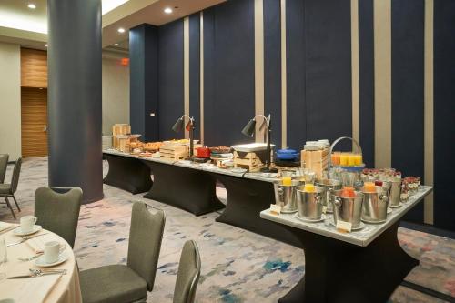 a long table with food on it in a room at The Lofton Hotel Minneapolis, Tapestry Collection by Hilton in Minneapolis