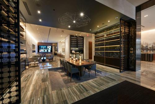 a wine tasting room with a table and a wine cellar at The Lofton Hotel Minneapolis, Tapestry Collection by Hilton in Minneapolis