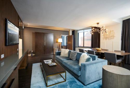 a living room with a couch and a table at The Lofton Hotel Minneapolis, Tapestry Collection by Hilton in Minneapolis