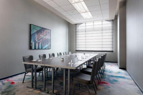 a conference room with a long table and chairs at The Lofton Hotel Minneapolis, Tapestry Collection by Hilton in Minneapolis