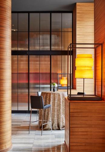 a dining room with a table and a lamp at The Lofton Hotel Minneapolis, Tapestry Collection by Hilton in Minneapolis