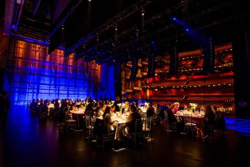 a group of people sitting at tables in a theatre at Loews Hollywood Hotel in Los Angeles