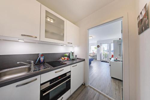 a kitchen with a sink and a stove top oven at Ferienwohnung Morgensonne in Schönwald