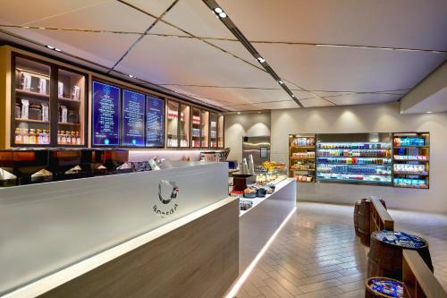 a restaurant with a bar with wine bottles at Loews Hollywood Hotel in Los Angeles