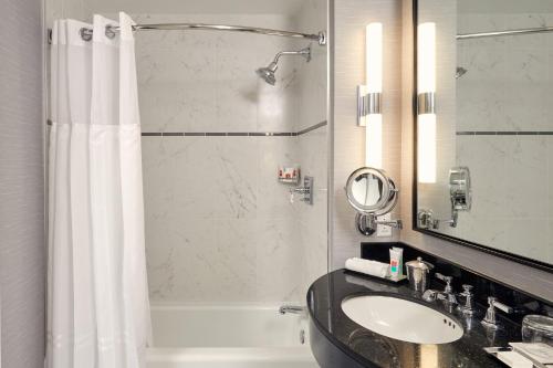 a bathroom with a sink and a shower at Loews Philadelphia Hotel in Philadelphia