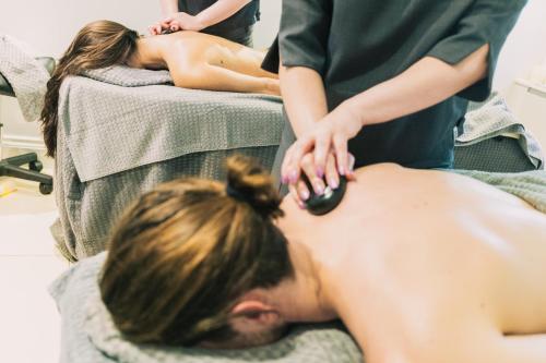 a man getting a back massage in a salon at Gonville Hotel in Cambridge