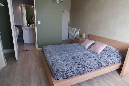 1 dormitorio con 1 cama grande con manta azul en Vaste appartement avec vue sur la Vienne, en Chinon