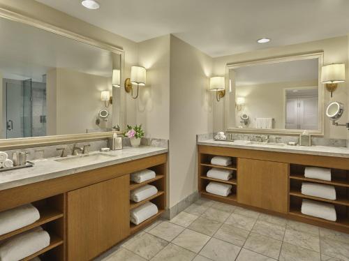 a bathroom with two sinks and a large mirror at Loews Coronado Bay Resort in San Diego