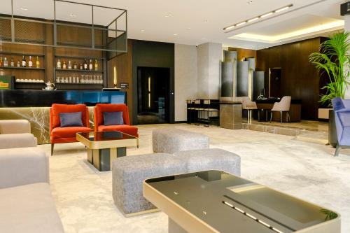 a lobby of a hotel with chairs and a bar at The Kailyn Hotels&Suites Ataşehir in Istanbul