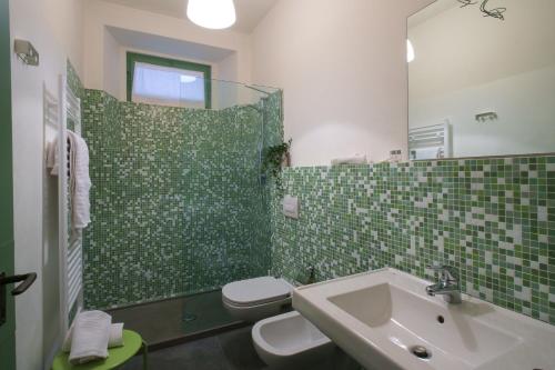 a bathroom with a sink and a toilet and a shower at Agriturismo Il Belvedere in Palazzago