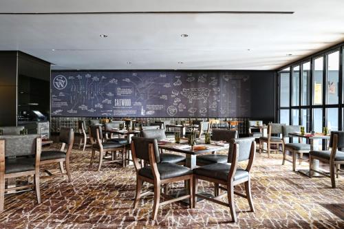 a restaurant with tables and chairs and a chalkboard at Loews Atlanta Hotel in Atlanta