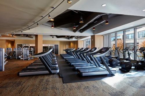 a gym with rows of treadmills and elliptical machines at Loews Atlanta Hotel in Atlanta
